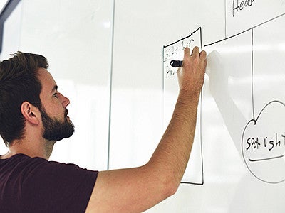 Man drawing on whiteboard Man drawing on whiteboard