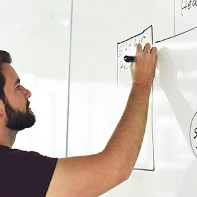 Man drawing on whiteboard Man drawing on whiteboard